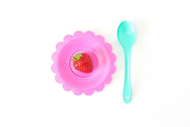 Strawberry on a bright saucer isolated white - Photo, Image