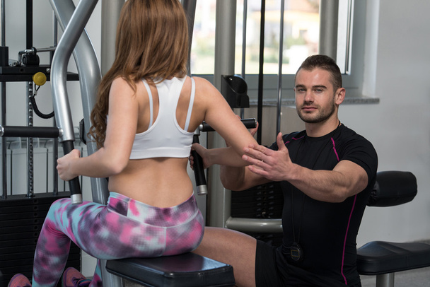 Personal Trainer Helping Client In Gym - Fotó, kép