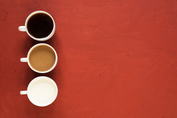 Three cups on red background - 写真・画像