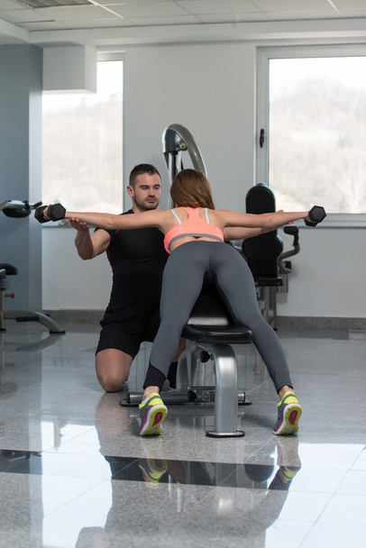 Personal Trainer ajudando a mulher no exercício de volta
 - Foto, Imagem