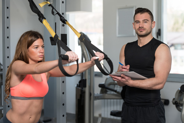 Trainer With Clipboard Woman On Trx Fitness Straps - Zdjęcie, obraz