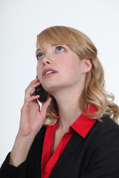 Blond office becoming stressed during telephone call - Фото, изображение