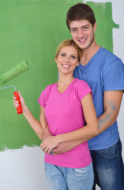 Happy couple paint wall at new home - Foto, Imagen