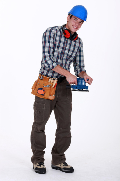 Workman with a sander - Фото, зображення