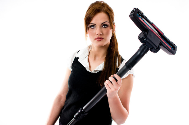 Beautiful brunette woman holding a vacuum cleaner - Fotoğraf, Görsel