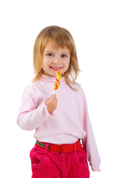 Little girl with a bright lollipop - Фото, зображення