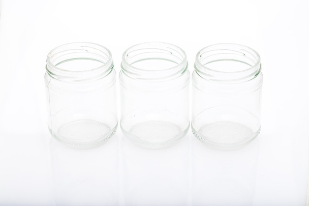 three little glass vases on a reflective surface - Foto, Imagem