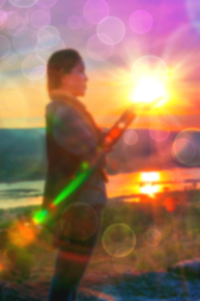 Abstract Blurred and soft photo of Women on hilltop with bokeh of sunrise on the natural background - Photo, Image
