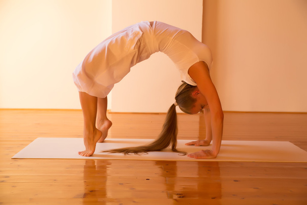 Woman practicing Yoga in a Attic		 - Foto, Bild