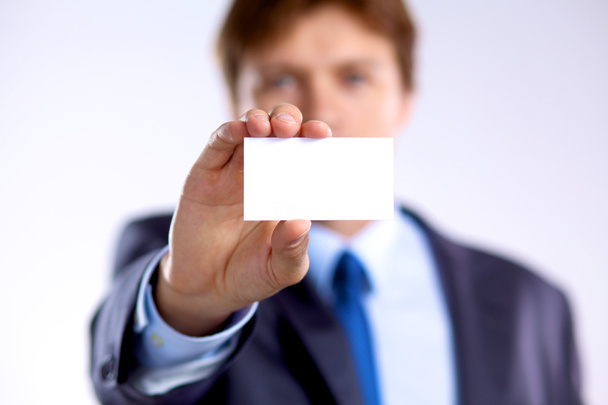 young businessman holds out his hand with a business card - Photo, Image