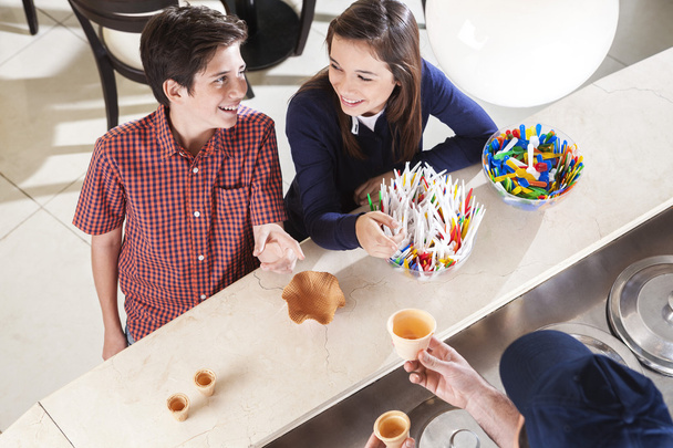 Siblings Looking At Each Other At Counter In Icecream Shop - Photo, Image
