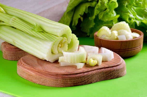 Celery stalks cut into slices on a kitchen Board - Photo, Image