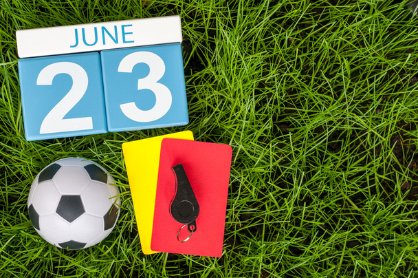 June 23rd. Image of june 23 wooden color calendar on green grass background with football outfit. Summer day - Foto, Bild