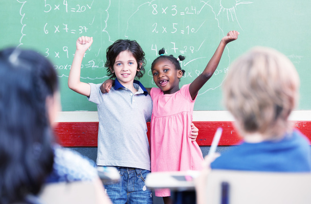 Schoolchild raising hand in classroom. Education concept - Photo, Image