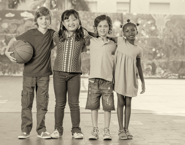 Elementary school children playing basketball at gym - Photo, Image