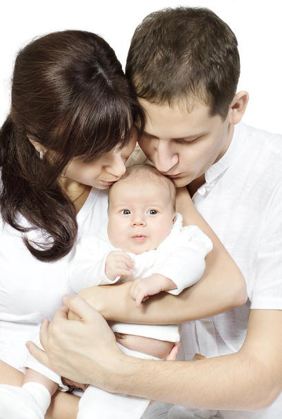 Parents kissing newborn baby over white background. Family love - Foto, Imagen