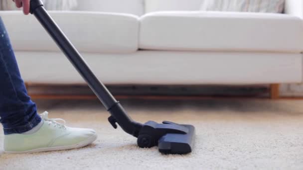 woman with vacuum cleaner cleaning carpet at home - Filmmaterial, Video