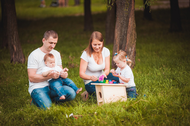 Happy family with nesting box and paints - Zdjęcie, obraz