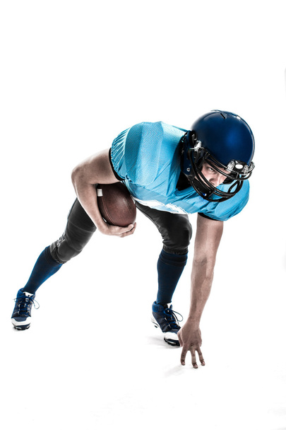 American Football Player with blue uniform on the scrimmage line. White background. - Foto, Bild