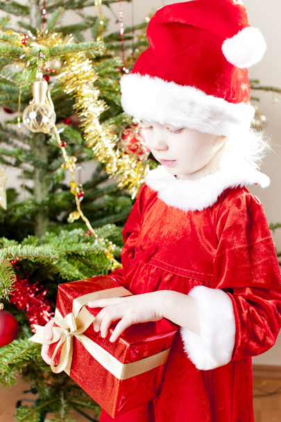 Little girl as Santa Claus with Christmas present - Photo, Image