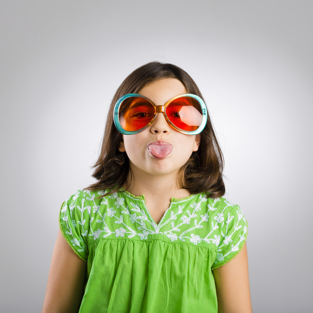 Girl in funny sunglasses sticking tongue out  - Foto, Imagem