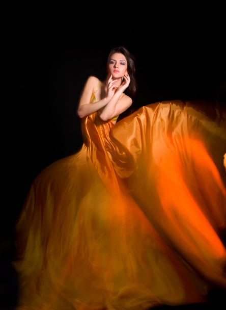Girl in the orange dress from flying fabric - Foto, Imagem