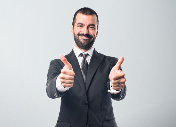 Businessman with thumb up - Foto, afbeelding
