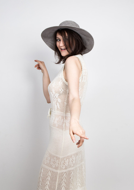 beautiful young brunette woman holding a broad-brimmed hat, she expression of different emotions - Foto, afbeelding