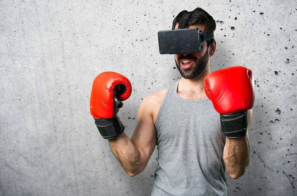 Sportman with boxing gloves and VR glasses - Foto, imagen