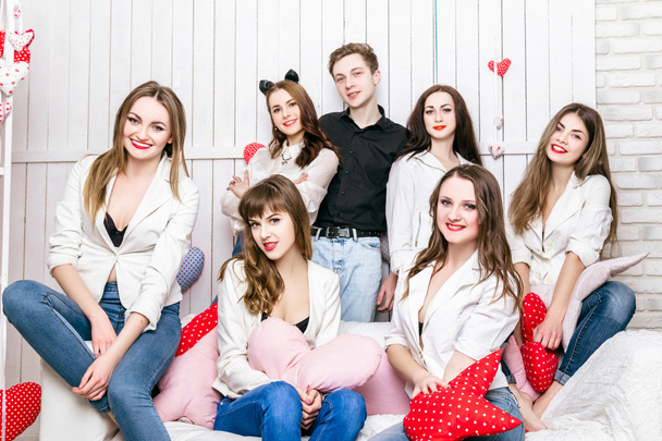 The company of six girls and boy on the couch - Фото, изображение