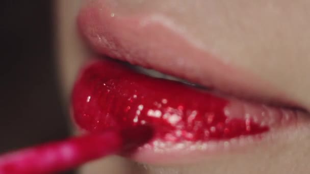 Professional make up stylist paints model's lips with lipstick - Footage, Video