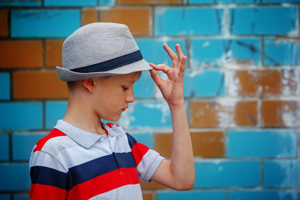 Stylish small boy in a summer hat stands in summer day. - Photo, Image