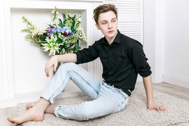 handsome guy dressed in black shirt and jeans posing - Foto, immagini