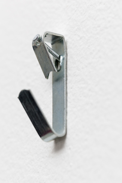 Macro of steel picture hook nailed to wall - Fotoğraf, Görsel