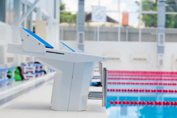 Starting blocks and lanes in a swimming pool - 写真・画像