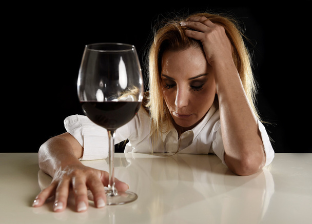 drunk alcoholic blond woman alone in wasted depressed drinking red wine glass suffering hangover - Photo, Image