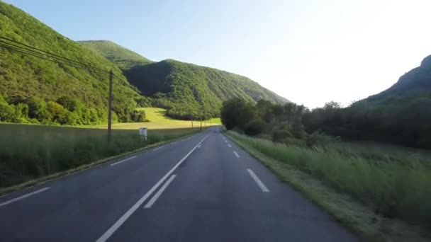 Motor home car driving on two lane highway in daylight at sunset. Point of view video from car mounted camera. Scenic landscape in Provence countryside, France. - Footage, Video