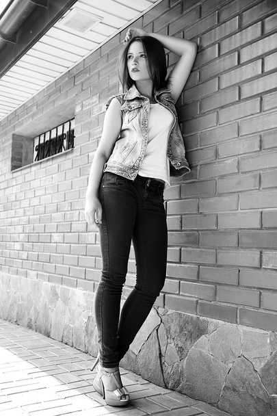 Young woman standing outdoors. fashion portrait. Black and white - Φωτογραφία, εικόνα