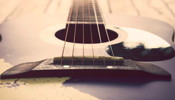 Vintage tone: guitar on wood table - Photo, Image