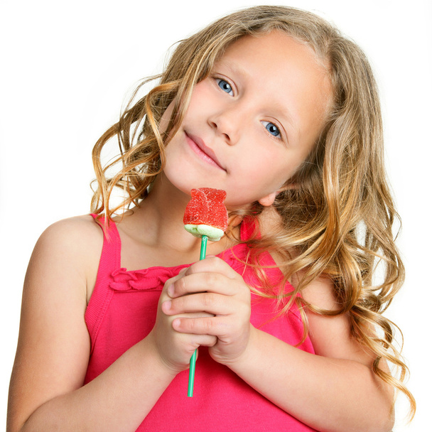 Close up of cute girl holding candy rose. - Photo, Image