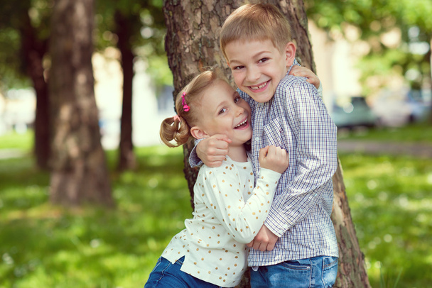 Portrait of two happy cute kids summer park - Photo, Image