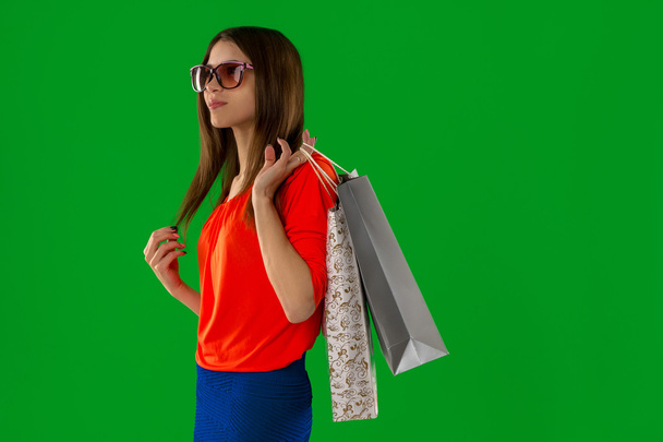 brunette woman in glasses with shopping bag in hands - Foto, Imagem