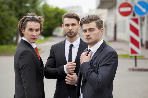Three young men in elegant business suits - Fotoğraf, Görsel