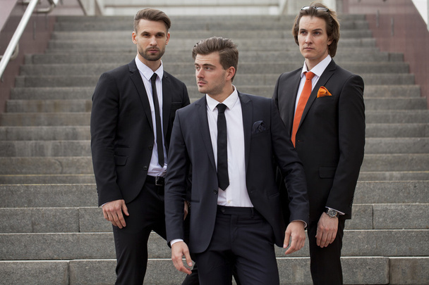 Three young men in elegant business suits - Фото, изображение