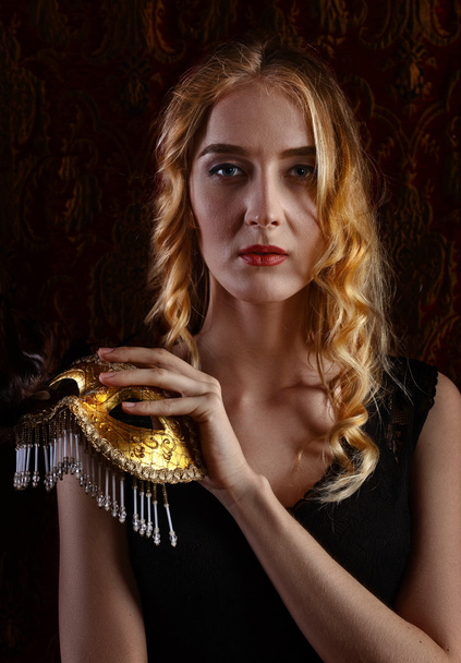Młoda piękna blondynka z maską wenecka złota - Zdjęcie, obraz