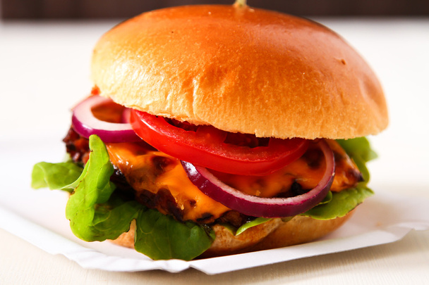 Delicious fresh homemade burger with spicy tomato sauce and beef - Photo, Image