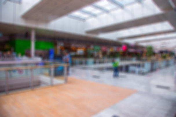 Blurred interior in shopping center. Shopping malls. Center passage in super market discount at the blur background - Photo, Image
