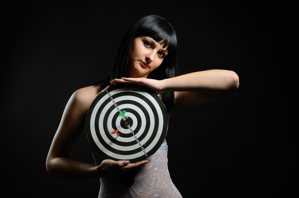 Young woman with a target in the dark - Foto, immagini