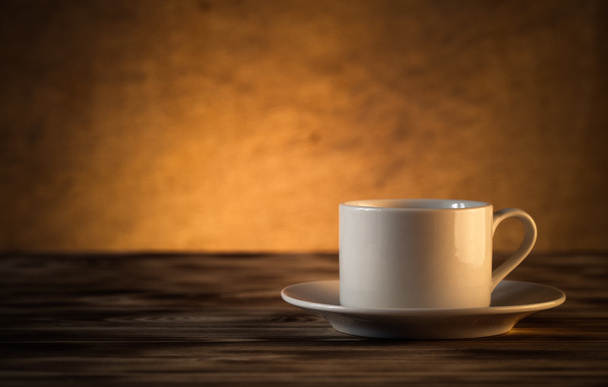 Cup of tea on light wooden table on blur jute background. Select - Valokuva, kuva