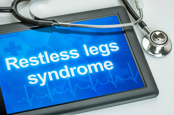 Tableta con el diagnóstico Síndrome de piernas inquietas en la pantalla
 - Foto, Imagen